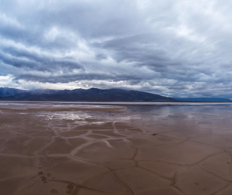 Cracked mud and salt on the valley floor in Death Valley National Park in California can become a reflective pool after rains