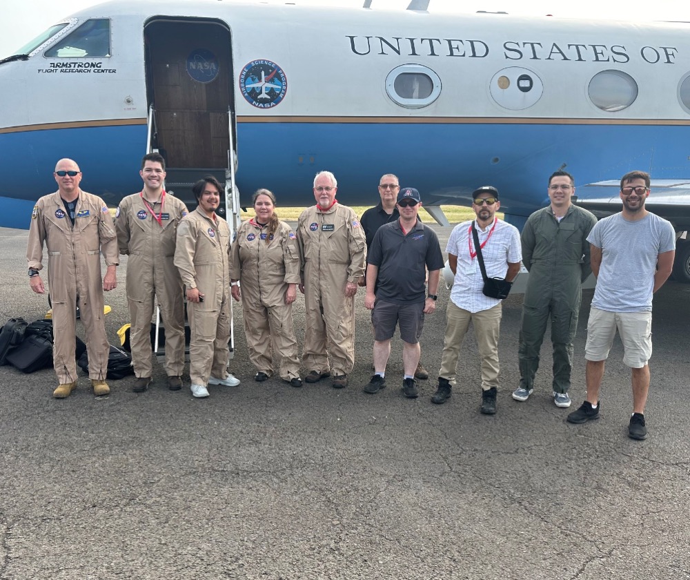 NASA team members pose in front of the C-20A aircraft while in Sao Tome, Africa, May 24, 2024. From left, Kirt Stallings, Joe Piotrowski Jr., Adam Vaccaro, Carrie Worth, Tim Miller, Otis Allen, Roger “Todd” Renfro, Edgar Aragon-Torres, Ryan Applegate, and Isac Mata