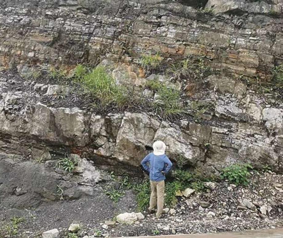 A person looks at cap carbonate rocks in South China in 2019.