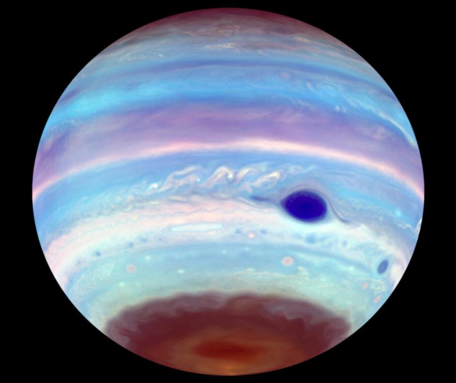 This is Jupiter in ultraviolet light. This image takes what we normally see in optical light as an orange- and cream-colored world … and turns it blue and lavender.