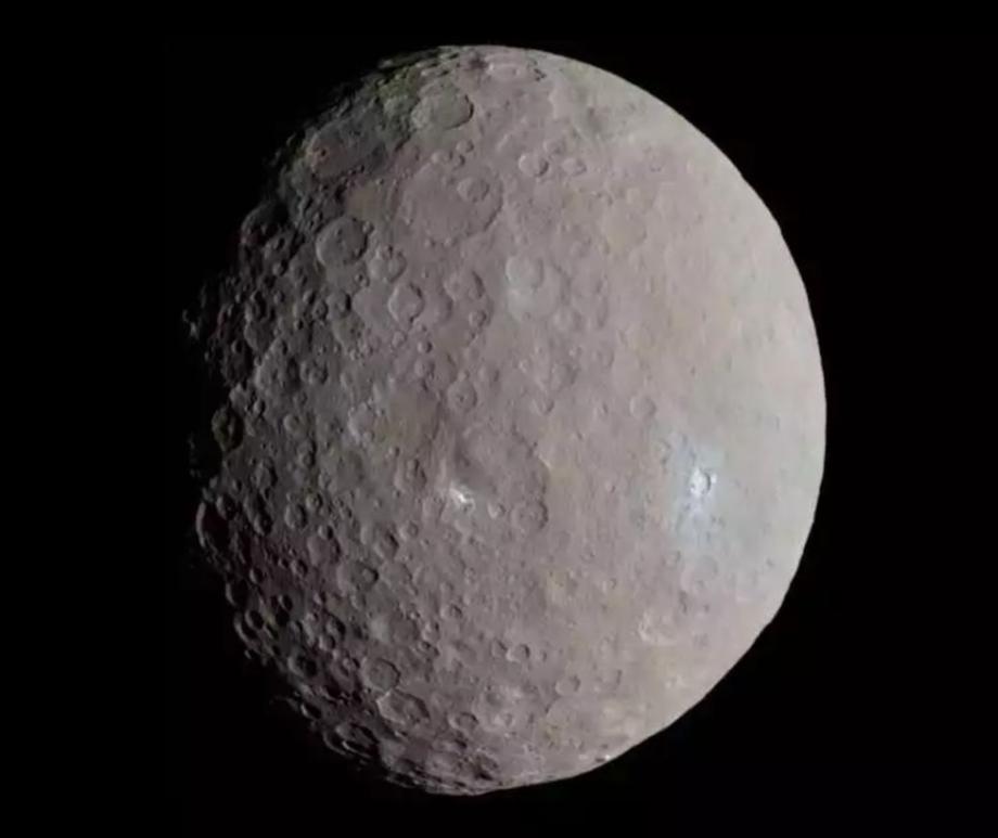 NASA’s Dawn spacecraft captured this approximately true-color image of Ceres in 2015 as it approached the dwarf planet. Dawn showed that some polar craters on Ceres hold ancient ice, but new research suggests the ice is much younger. 