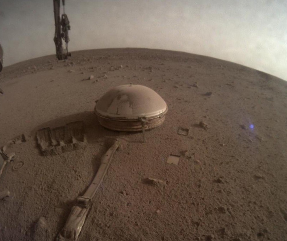 One of the last images ever taken by NASA's InSight Mars lander shows its seismometer on the red planet's surface in 2022