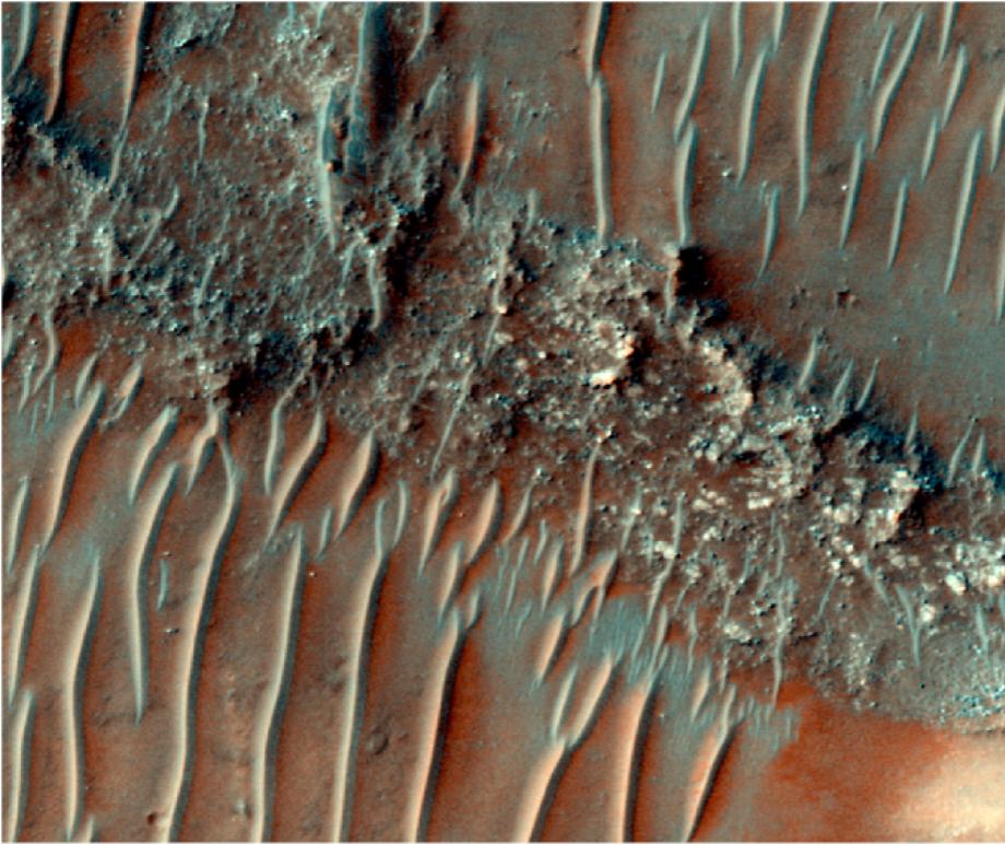 Colour image of a flat top, heavily eroded fluvial sinuous ridge (FSR) on Mars. Sand dunes can be seen migrating over the top of the FSR.