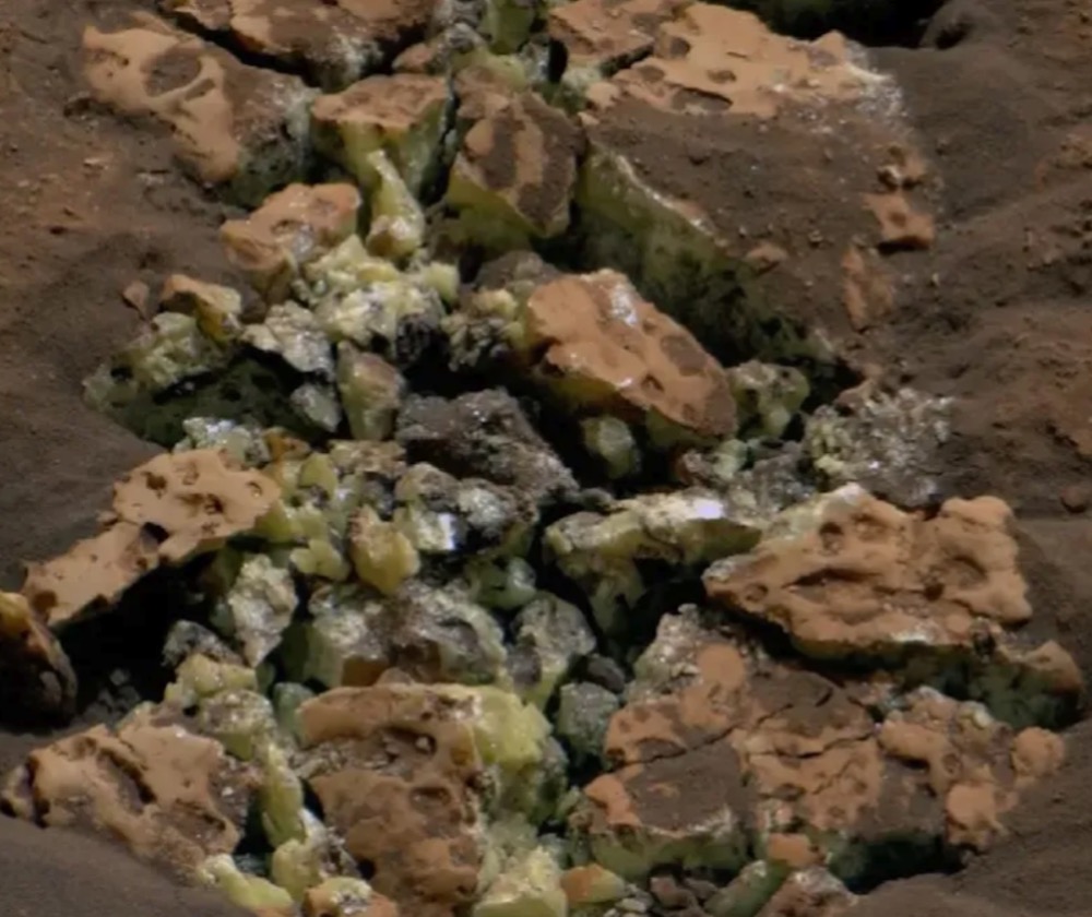 Yellow crystals of pure, elemental sulfur appear inside a crushed Mars rock that NASA's Curiosity rover accidentally drove over