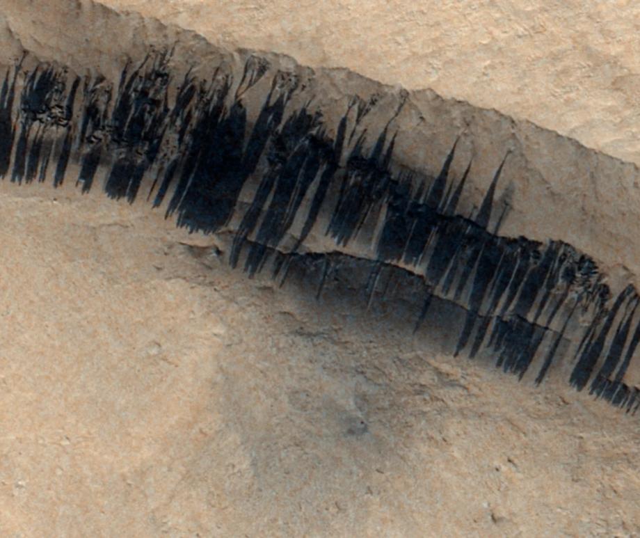Dust avalanches streak the slopes near Apollinaris Mons on Mars in this image captured by European Space Agency's ExoMars Trace Gas Orbiter on Dec. 24, 2023