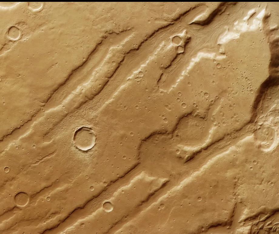 Coloe Fossae on Mars, a region marked by deep valleys and craters that reveals evidence of an ancient ice age.