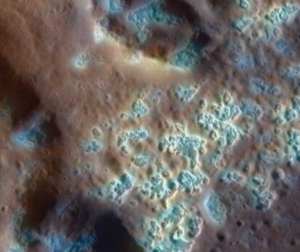 This enhanced-color Messenger image of Mercury shows mysterious pits (whitish blue), known as hollows, that may have formed from vaporizing solid materials