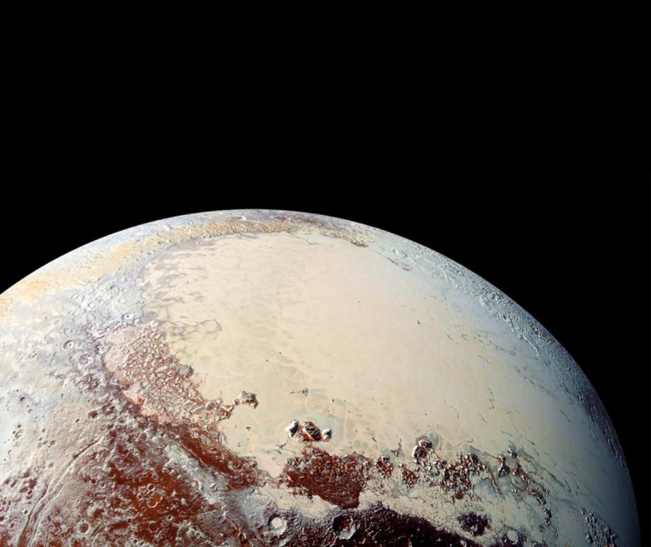 A close up of Pluto's surface shows ice and impact craters.