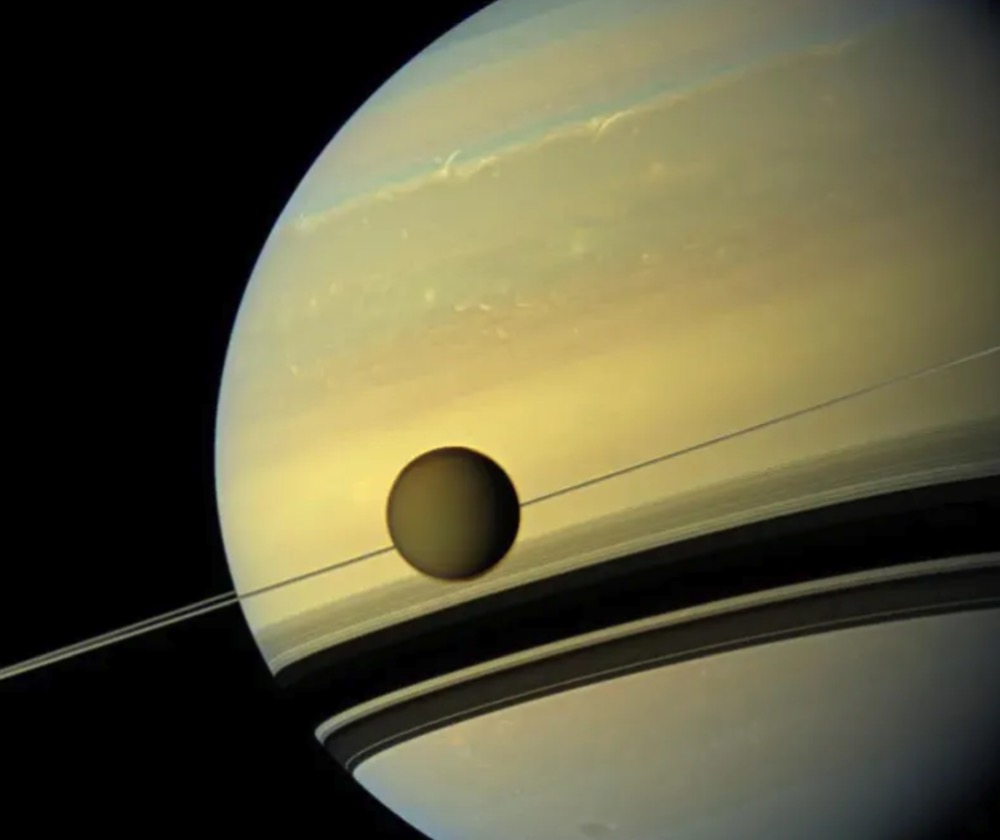 Titan is seen here as it orbits Saturn