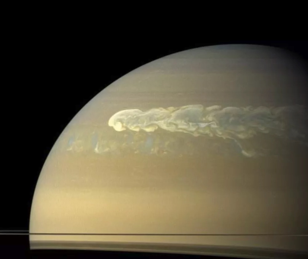 An image of Saturn taken by the Cassini probe show storms raging across the gas giant's surface
