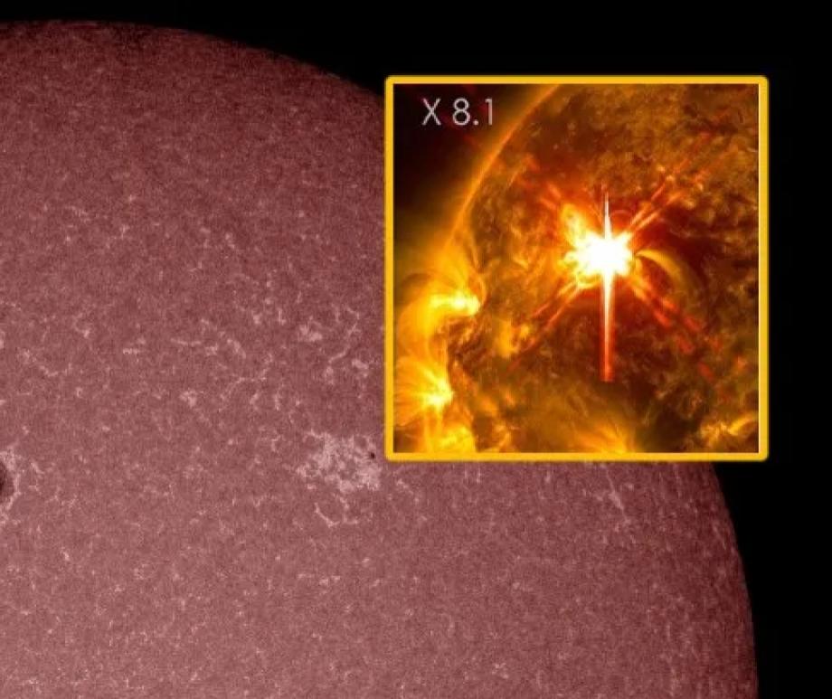 Sunspot region 4366 (black dots) just fired off the strongest solar flare in years (inset), making auroras likely this week.