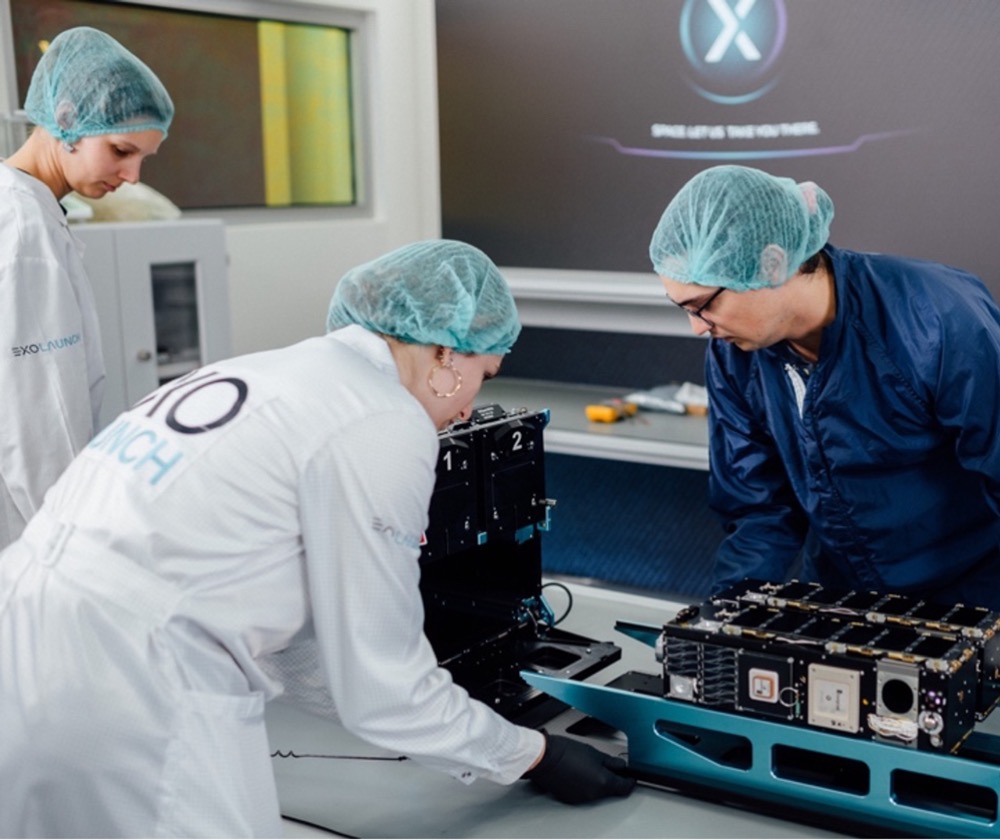 CURIE team members work on integrating the satellites into the CubeSat deployer