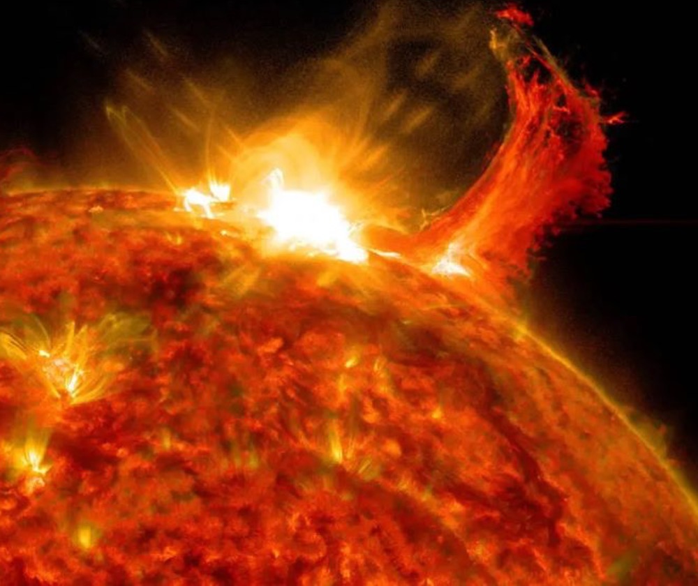 Image of a solar flare (bright flash) obtained by NASA’s Solar Dynamics Observatory on Oct. 2, 2014, with a burst of solar material erupting being observed just to the right of the solar flare