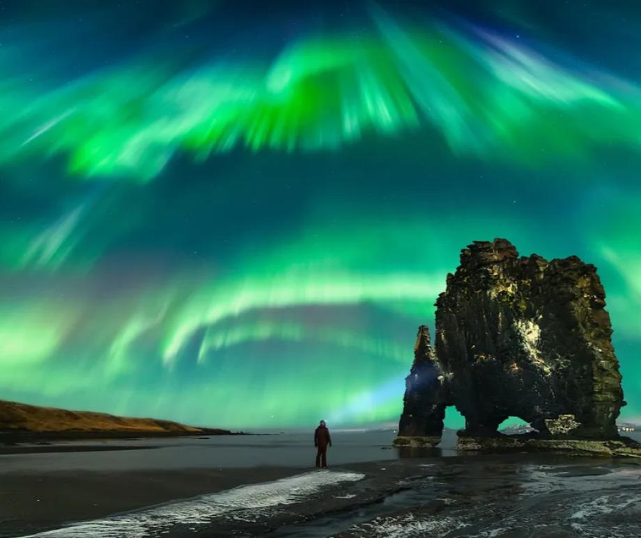 Northern lights dance above Hvítserkur rock formation, Northwest Iceland