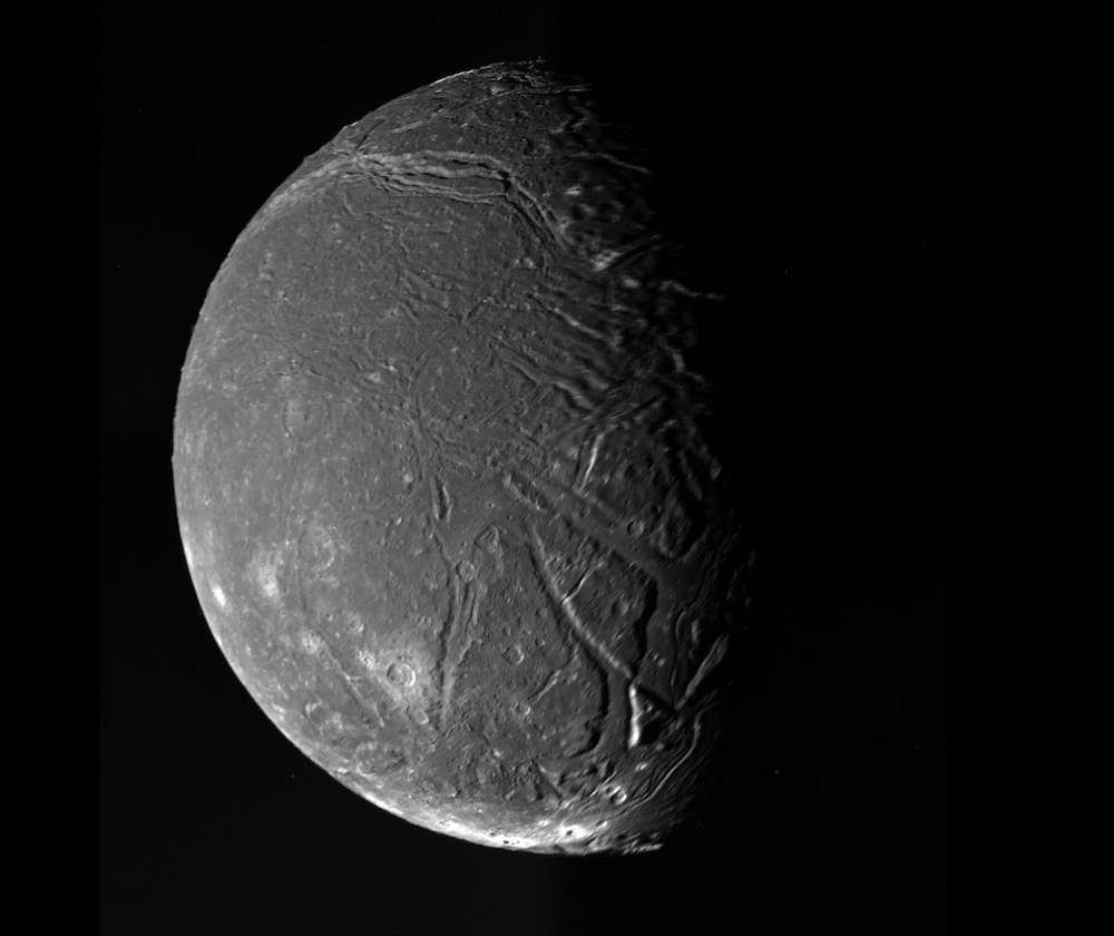 This is a moon of the planet Uranus – named Ariel – as seen by the one and only spacecraft ever to have visited Uranus, Voyager 2 in 1986